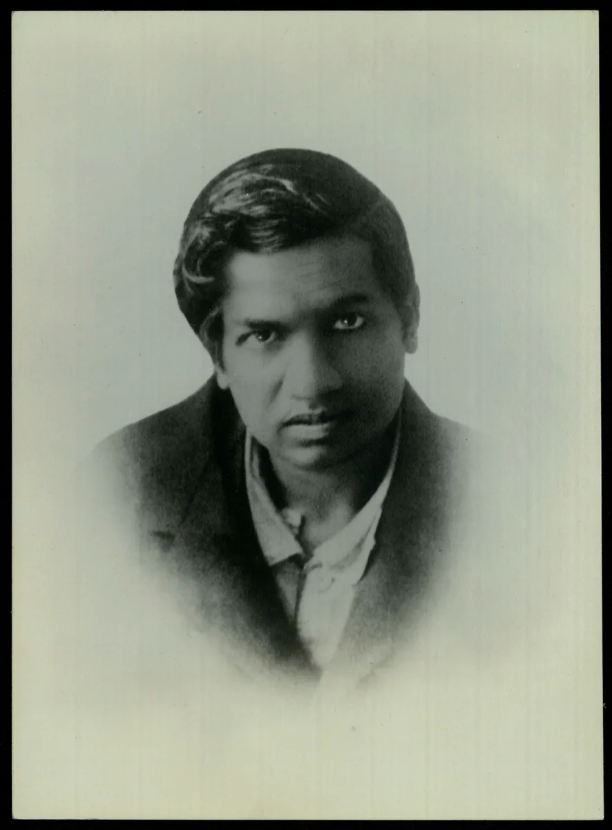 A copy passport photograph of Ramanujan made around 1913, held among the college's manuscripts.